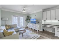Cozy living room features stylish furniture, modern decor, and access to a balcony at 1755 Central Park Rd # 7203, Charleston, SC 29412