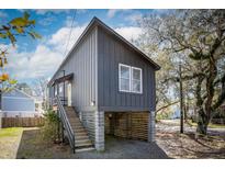Two-story modern home featuring a raised foundation and a vertical plank design for a contemporary look at 1981 Central Park Rd, Charleston, SC 29412