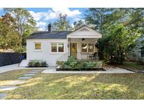 Charming bungalow featuring a landscaped front yard, a cozy front porch, and a freshly painted exterior at 2115 Wappoo Dr, Charleston, SC 29412