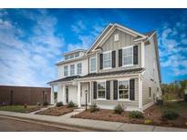 Charming new two-story home with gray and white siding, black shutters, and manicured front yard under a blue sky at 217 Abercom Place Dr, Moncks Corner, SC 29461