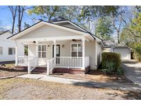 Charming single-story home featuring a cozy front porch, neutral siding, and well-maintained landscaping at 25 Oak Forest Dr, Charleston, SC 29407