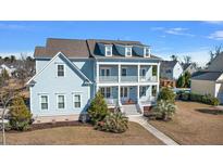 Charming two-story home with a welcoming double porch and a manicured lawn at 3003 Yachtsman Dr, Mount Pleasant, SC 29466