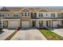 Charming townhome with two-car garage, neutral siding, manicured lawn, and concrete driveway at 509 Nadir Ct, Summerville, SC 29486