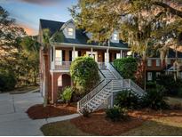 Charming brick home with a inviting double staircase and landscaped front yard, creating a picturesque curb appeal at 669 Palisades Dr, Mount Pleasant, SC 29464