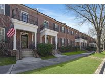 Charming brick townhomes featuring manicured lawns and inviting entrances on a sunny day at 871 Center Park St, Charleston, SC 29492