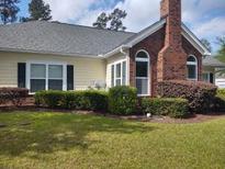 Charming exterior of this home featuring a classic brick chimney and manicured landscaping at 8800 Dorchester Rd # 502, North Charleston, SC 29420
