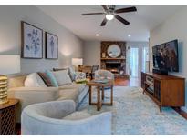 Inviting living room features a brick fireplace, ceiling fan, and comfortable seating, perfect for relaxation at 960 Mooring Dr, Charleston, SC 29412