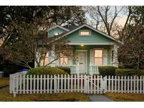 Charming home exterior featuring a picket fence, tidy landscaping, and a cozy covered porch at 103 Tall Oak Ave, Charleston, SC 29407