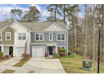 Charming two-story home with a one-car garage and well-manicured landscaping at 127 Rosefield Ct, Summerville, SC 29485