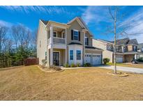 Charming two-story home featuring a covered porch, two-car garage, and well-maintained lawn at 1273 Discovery Dr, Ladson, SC 29456