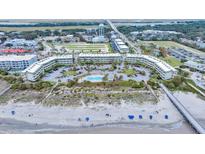 Breathtaking aerial view of beachside condos and pool, offering stunning coastal living and resort-style amenities at 1300 Ocean Blvd # 114 A, Isle of Palms, SC 29451