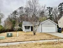 Charming single Gathering home featuring a well-maintained front yard and attached two car garage at 344 Eagle Ridge Rd, Summerville, SC 29485