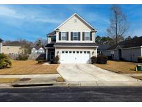 Charming two-story home featuring a two-car garage, landscaped yard, and classic architectural details at 3614 Haymont Ln, Ladson, SC 29456