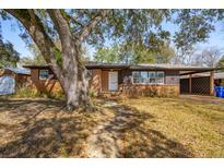 Charming brick home with covered carport, white door, and mature landscaping at 5520 Gale St, North Charleston, SC 29406