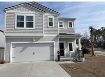 Charming two-story home featuring a two-car garage, landscaped yard and traditional architectural details at 634 Jancus St, Charleston, SC 29414