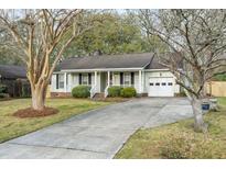 Charming single-story home with a well-maintained lawn, driveway, and attached garage at 643 Semaht St, Charleston, SC 29412