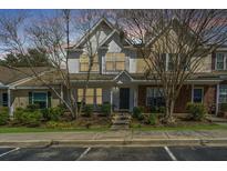 Inviting townhome exterior with a charming front porch and well-maintained landscaping for curb appeal at 7977 Shadow Oak Dr, North Charleston, SC 29406