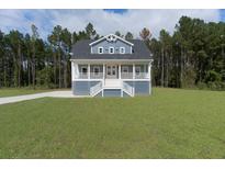 Charming home featuring a spacious porch, two stories, and a beautifully landscaped yard at 1329 Wood Sorrel Dr, Moncks Corner, SC 29461