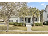 Charming home with a welcoming front porch, lush landscaping, and mature trees at 1357 Osmond Rd, Mount Pleasant, SC 29466