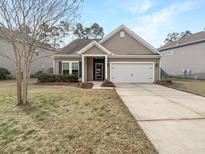Charming one-story home features a well-maintained lawn and a two-car garage at 139 Gazania Way, Charleston, SC 29414