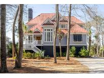 Charming two-story home featuring a red roof, gray siding, elevated structure, and a welcoming white staircase at 1464 Dupree Creek Rd, Awendaw, SC 29429