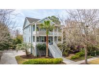 Charming two-story home featuring double porches, lush landscaping, and a grand entrance staircase at 1543 Wando Landing St, Charleston, SC 29492