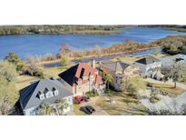 Stunning aerial view of waterfront homes with beautifully landscaped yards along a serene river at 1739 Indigo Island Dr, Hanahan, SC 29410