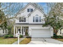 Charming two-story traditional home with white siding, a two-car garage, and well-maintained landscaping at 1924 Treebark Dr, Charleston, SC 29414
