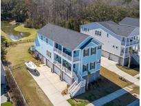 Stunning aerial view of a coastal home with multi-level decks and boat parking at 2305 Sturgeon, Johns Island, SC 29455