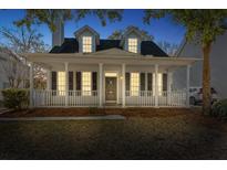Charming two-story home with a welcoming front porch, white pillars and classic black shutters at 2461 Fulford Ct, Mount Pleasant, SC 29466