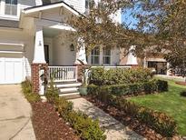 Charming home featuring a welcoming front porch and professionally landscaped yard with walkway at 3608 Maidstone Dr, Mount Pleasant, SC 29466