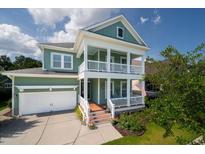 Charming two-story home with a welcoming front porch, white railings, and a well-manicured front yard at 3664 Maidstone Dr, Mount Pleasant, SC 29466