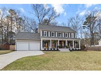 Charming two-story home featuring a welcoming front porch and a spacious two-car garage at 404 Black Oak Blvd, Summerville, SC 29485