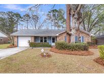 Charming single-story brick home with blue shutters and a well-maintained front yard at 4604 Garwood Dr, Ladson, SC 29456