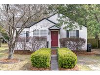Charming home featuring a red front door, neatly trimmed bushes, and vinyl siding at 4758 Aster Dr, North Charleston, SC 29405