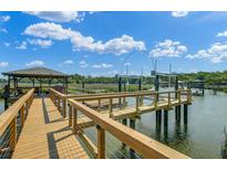Waterfront property featuring private dock with boat lift and gazebo at 8704 Middleton Point Ln, Edisto Island, SC 29438