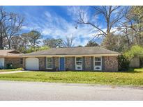 Charming brick home featuring a well-maintained lawn and a bright blue front door at 103 Sprucewood Dr, Summerville, SC 29485
