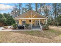 Charming cottage-style home with a welcoming front porch, perfect for relaxing and enjoying the outdoors at 104 Gervais St, Walterboro, SC 29488