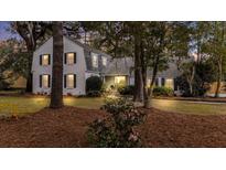 Charming white brick home featuring a manicured lawn and mature trees at 107 President Cir, Summerville, SC 29483