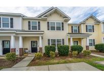 Inviting townhouse with a well-maintained lawn and charming front porch at 138 Hidden Palms Blvd, Summerville, SC 29485