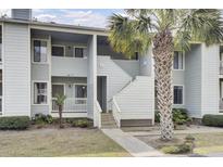 This is a charming multi-story condo building with stairs leading to the upper units and lush landscaping at 1481 Center Street Ext # 601, Mount Pleasant, SC 29464