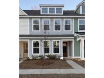 Charming two-story townhome showcasing a light blue exterior, large windows, and inviting curb appeal at 161 Cantona Dr, Summerville, SC 29483