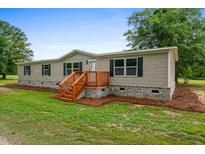 Charming single-story home featuring a welcoming front porch and well-maintained yard at 1657 Short Cut Rd, Cross, SC 29436