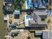 Expansive aerial view of a waterfront home with a private pool and boat dock for convenient water access at 1886 Capri Dr, Charleston, SC 29407