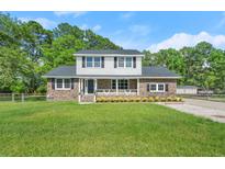 Charming brick home with a spacious front yard and inviting curb appeal at 203 Horseshoe Rd, Moncks Corner, SC 29461