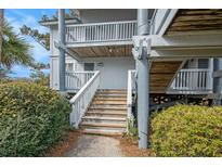 Attractive condo featuring a stairway entrance and well-maintained landscaping at 27 Lagoon Villas, Isle of Palms, SC 29451