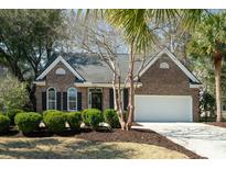 Charming single-story brick home with manicured landscaping and an attached two-car garage at 3425 Oxfordshire Ln, Mount Pleasant, SC 29466