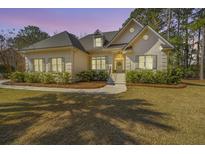 Charming one-story home with brick exterior, manicured lawn, and mature trees at 3775 Colonel Vanderhorst Cir, Mount Pleasant, SC 29466