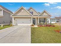 Charming single-Gathering home showcasing a manicured lawn, inviting front porch, and a two-car garage at 667 Black Pine Rd, Moncks Corner, SC 29461