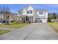 Charming two-story home featuring a spacious driveway and attached two-car garage at 127 Stagecoach Ln, Summerville, SC 29483